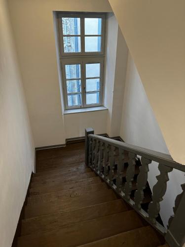 a stairway with a window and a stair case at 2 pièces parking, plein centre au calme climatisé in Foix