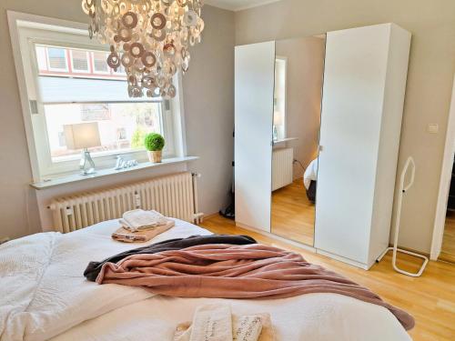 a bedroom with a bed and a large mirror at Chalet an der Bode - Schicke 3 Zi Fewo mit Balkon in Braunlage