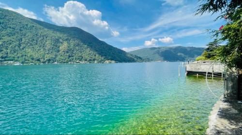 a view of a lake with mountains in the background at Lugano Lakefront - Private Beach & Pool in Melano