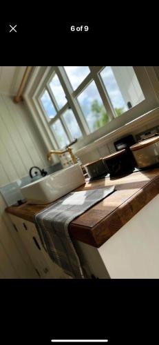 a kitchen counter with a window and a counter top at The Meadows Hut in Alvington