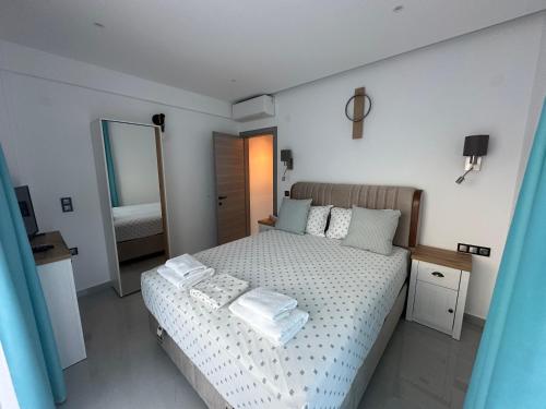 a bedroom with a bed with towels on it at Danielli Luxury Villas in Skala Rachoniou