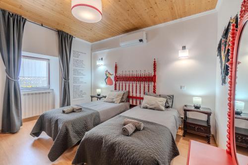 a bedroom with two beds with towels on them at Sotam Country House EN342 in Góis