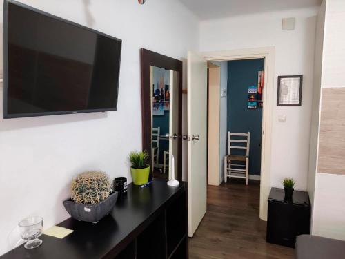 a living room with a flat screen tv on a wall at Hab Moderna A 20 Minutos del Centro de Barcelona in Santa Coloma de Gramanet