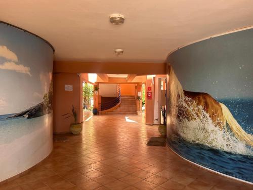 a hallway with a large painting on the wall at Imi Waves Studio - Steps from Beach & Surf Spot, Imi ouaddar in Imi Ouaddar