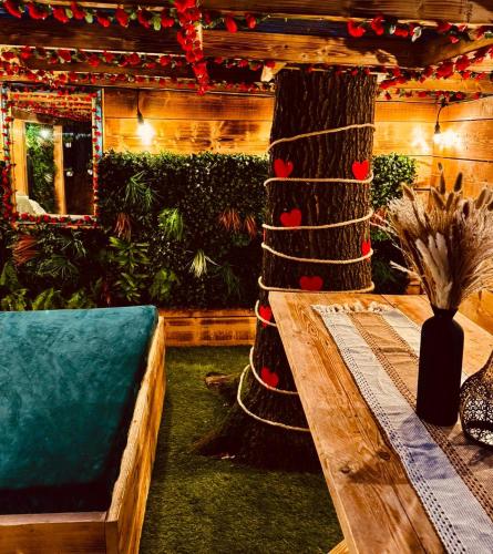 a living room with a wooden table and a couch at Sherwood Castle by Liv Retreats in Nottingham