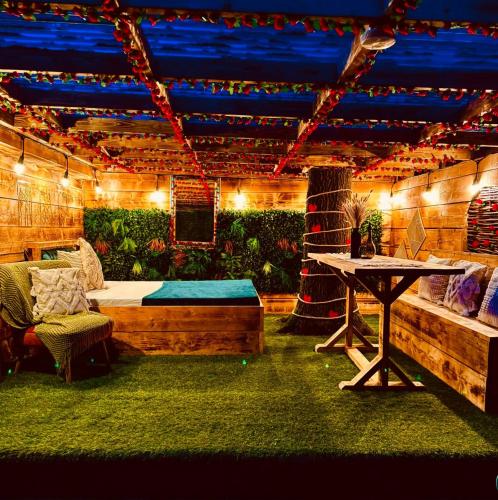 a room with a bed and a table with lights at Sherwood Castle by Liv Retreats in Nottingham