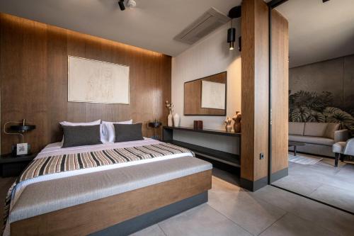 a bedroom with a large bed and a couch at Voger Bodrum by The Sea in Yalıkavak