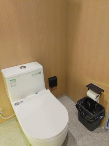 a bathroom with a white toilet in a room at Grace Hotel in Honiara