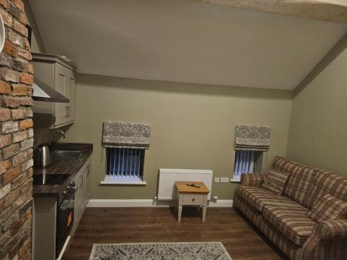 a living room with a couch and a table at The Manor Guest Accommodation Dungiven in Dungiven