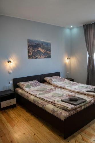 a bedroom with two beds and a window and a bedvisor at Къща за гости Белоградчик in Belogradchik