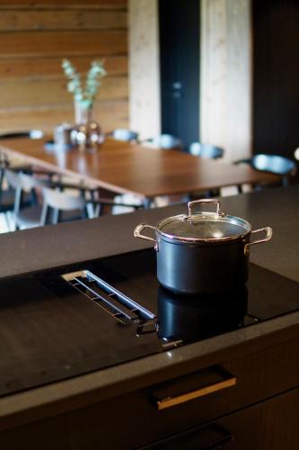 a pot sitting on top of a stove with a table at Exclusive Fjord Lodge with Private Jacuzzi and Epic Views in Lii