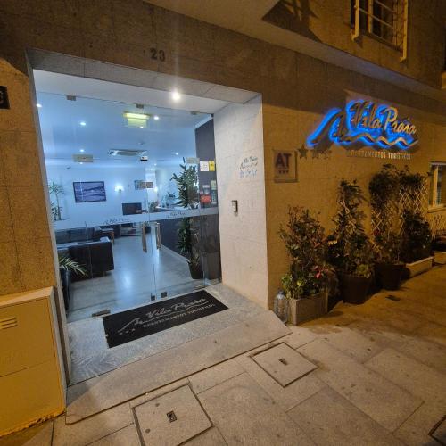 an entrance to a restaurant with a sign on the wall at Apartamentos Turísticos Vila Praia in Vila Praia de Âncora