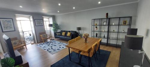 a living room with a table and a couch at Casa da Ladeira in Angra do Heroísmo