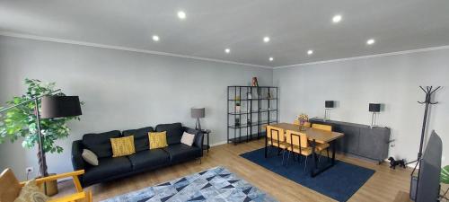 a living room with a couch and a table at Casa da Ladeira in Angra do Heroísmo