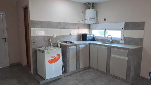 a small kitchen with a refrigerator and a sink at 25deMayo in Veinticinco de Mayo