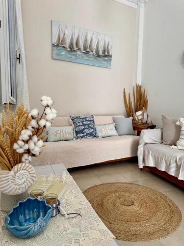 a living room with a couch and a table at Kirki Rooms by the sea in Parikia