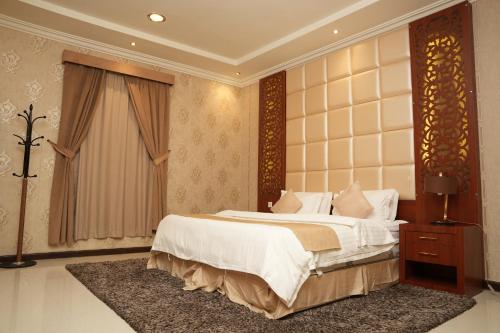 a bedroom with a large bed and a window at ELGOUN Serviced apartments in Riyadh