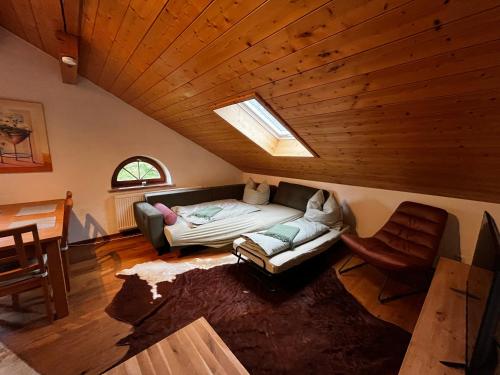 a living room with a couch and a table and a window at Biohof Liebhart in Obing