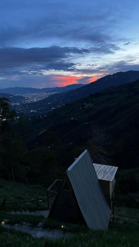 a house with a solar panel on top of a hill at Chalet Guadalupe - Girardota 