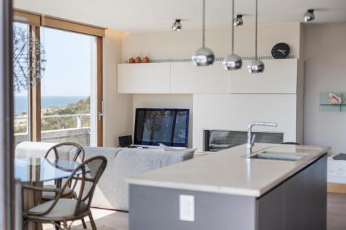 a kitchen and living room with a table and chairs at Shangri-La 0202 G in Sint-Idesbald