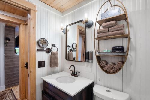 a bathroom with a sink and a mirror at Cozy Cottages Red Cottage Hot tubTown in Saugatuck