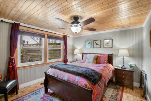 a bedroom with a bed and a ceiling fan at Cozy Cottages Brown Cottage Hot tubTown in Saugatuck