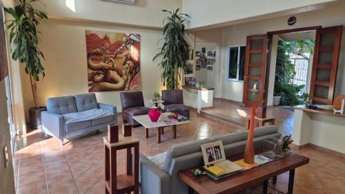a living room with a couch and a table at Private bedroom in gorgeous shared Versailles house with heated and cooled pool in Puerto Vallarta