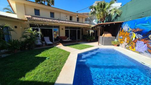 a house with a swimming pool in the yard at Private bedroom in gorgeous shared Versailles house with heated and cooled pool in Puerto Vallarta