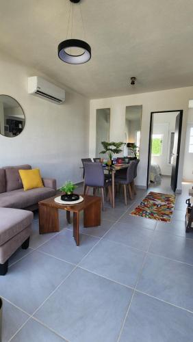 a living room with a couch and a table at Casa 3 recamaras con alberca compartida Acapulco diamante in General Juan N Alvarez International Airport