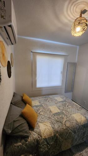 a bedroom with a bed in front of a window at Casa 3 recamaras con alberca compartida Acapulco diamante in General Juan N Alvarez International Airport