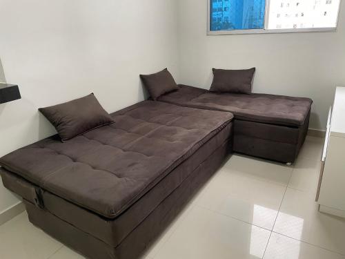 a large bed sitting in a room with at Apto condomínio Ônix in Campos dos Goytacazes