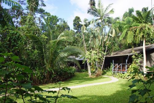 a path leading to a house in a garden at Heritage Lodge - in the Daintree in Daintree