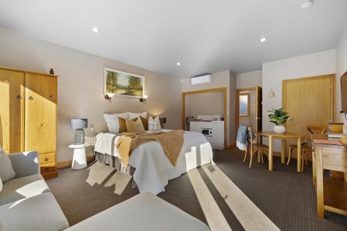 a hotel room with a large bed and a desk at The Shan's Lodge in Queenstown