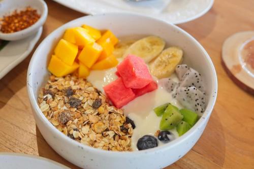 a bowl of cereal and fruit on a table at Ton Sai Tropical Phi Phi Island in Phi Phi Don