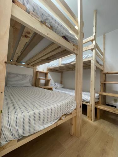 a bedroom with two bunk beds in a room at Alaska Backpacker Hostel in Anchorage