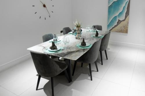 a dining room with a table and chairs at The VVS Apartments in Accra