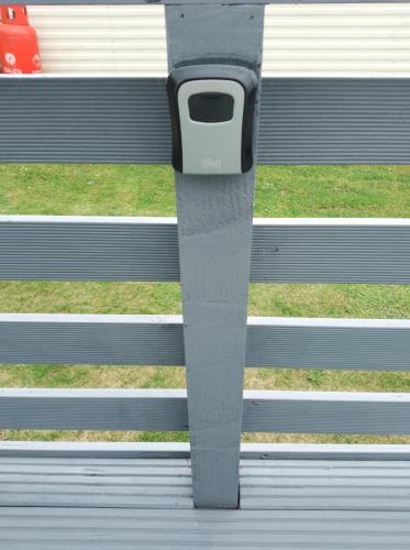 a bench with a cell phone sticking out of it at Cairnryan Loch View in Cairnryan