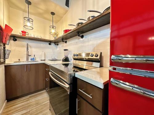 a kitchen with a stove and a red refrigerator at The Lofts At Santurce in San Juan