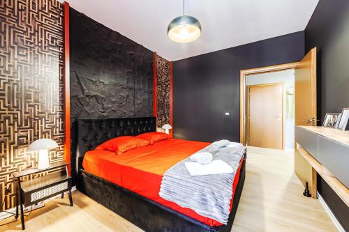 a bedroom with a large bed with red pillows at Premium Beachfront Residences in Durrës