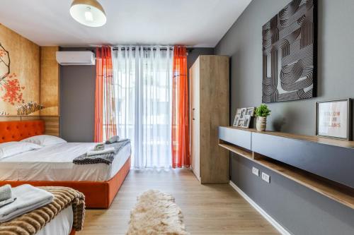 a bedroom with a bed and a large window at Premium Beachfront Residences in Durrës