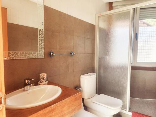 a bathroom with a sink and a toilet and a shower at Da Cañota, Hío-Aldán 200 m playa in Aldán