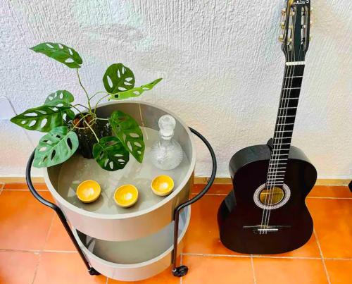 a guitar and a table with eggs and a guitar at Bugambilia Azul Centro Oaxaca in Oaxaca City
