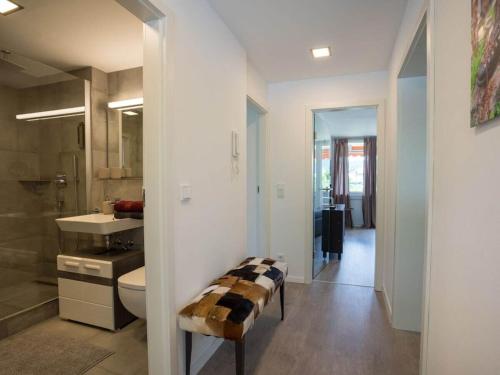 a bathroom with a toilet and a sink at 1-bedroom holiday apartment in Oberstdorf