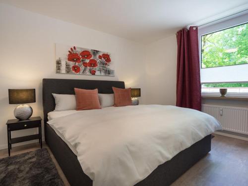 a bedroom with a large bed and a window at 1-bedroom holiday apartment in Oberstdorf