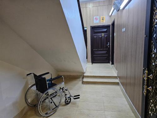 a wheelchair sitting in a hallway next to a door at Welcome One 5km far from Masjid Nabawi in Al Madinah