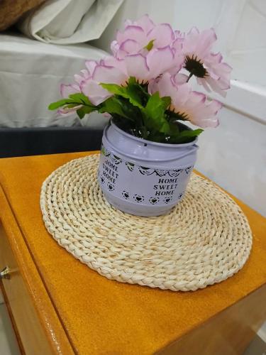 a vase filled with pink flowers sitting on a table at Yashira Boutique Hotel in Bogotá