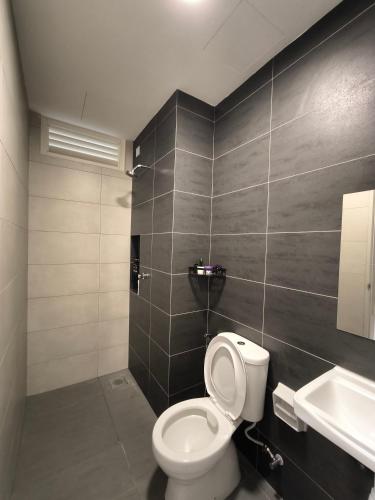 a bathroom with a toilet and a sink at Horizon Staycation w WiFi in Sepang