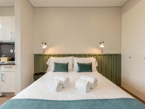 a bedroom with a large white bed with two pillows at Feel Porto Wine Essence II in Vila Nova de Gaia