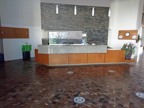 a lobby with a reception desk in a building at La Palapa Acapulco in Acapulco