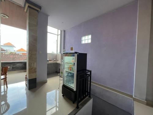 a large refrigerator in a room with a window at Twowi House Ubud in Ubud
